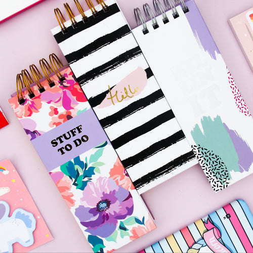Collection of colorful notepads with various designs